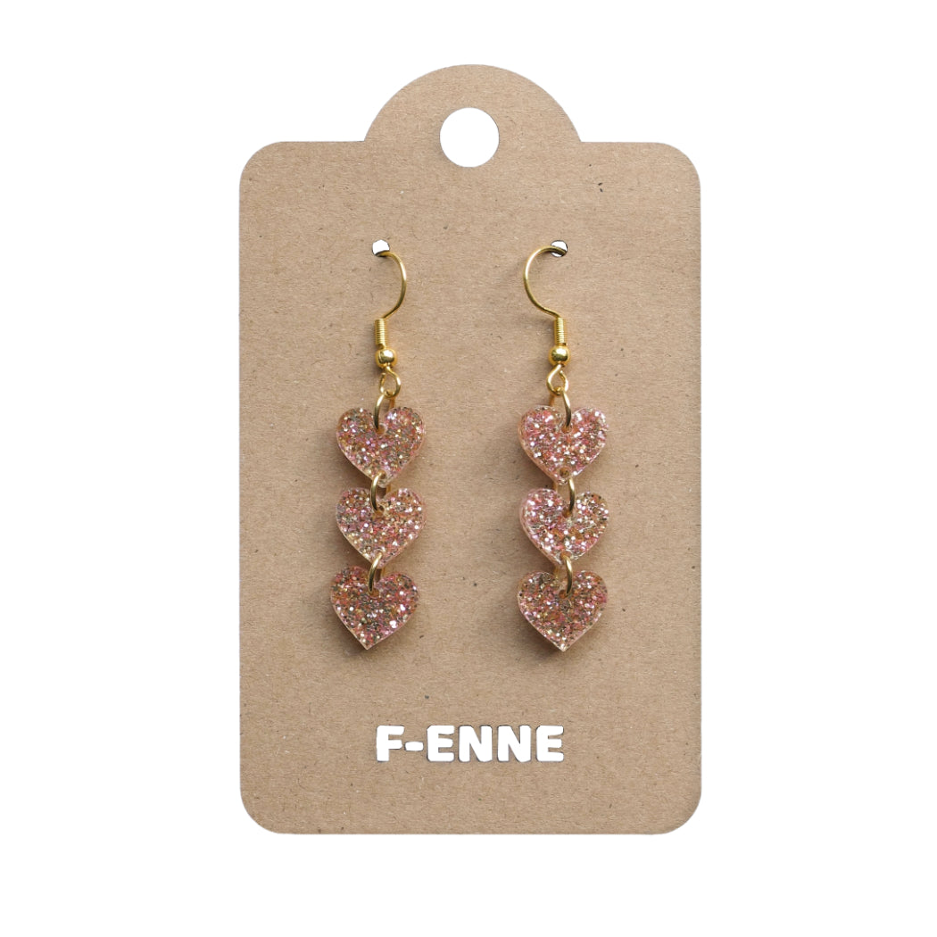Triple hartjes oorbellen - glitter acryl - goudkleurig